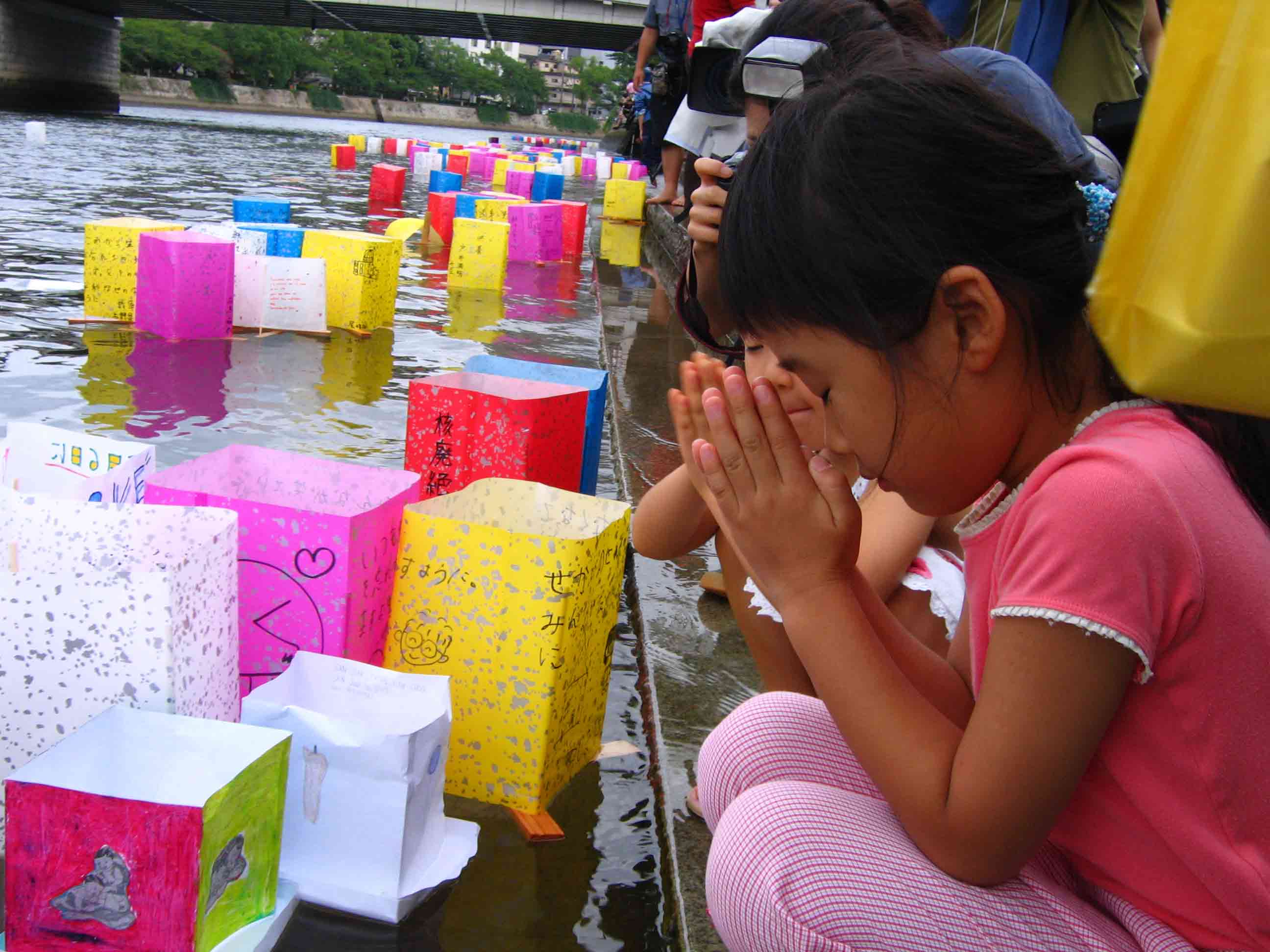 Girl offers peace prayers at launch of peace lanterns